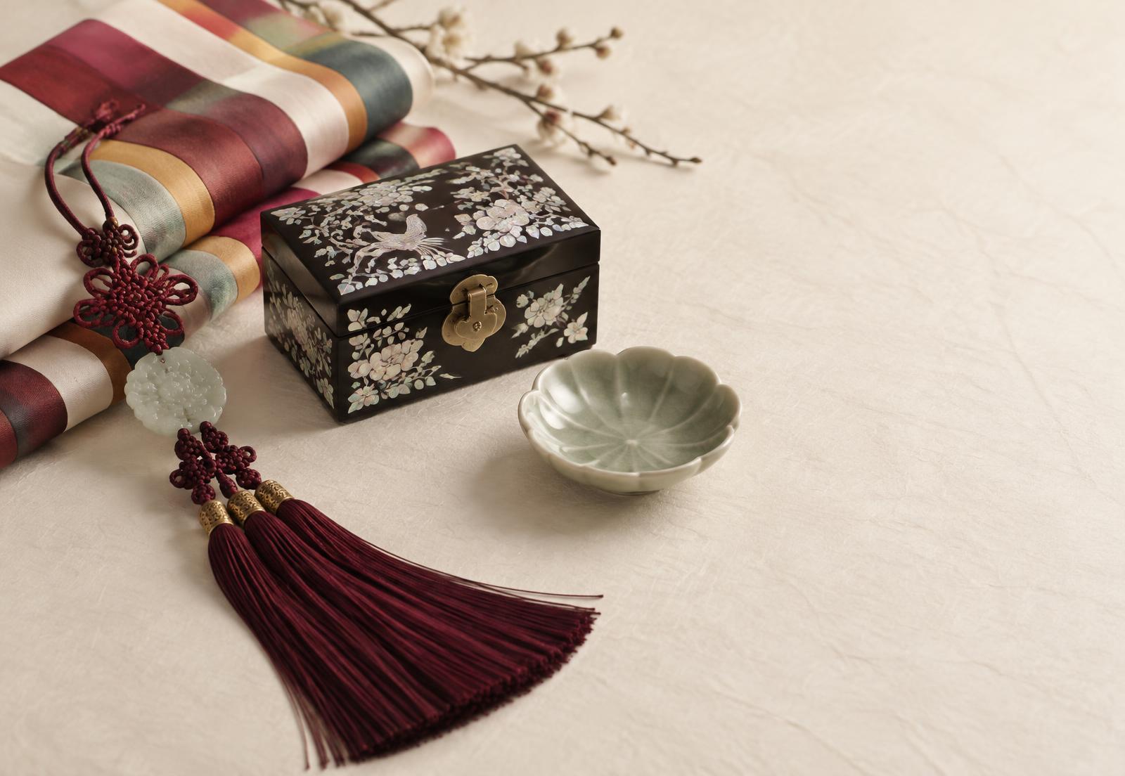 Korean norigae tassel, mother-of-pearl inlaid box, saekdong silk and a celadon dish arranged on hanji paper